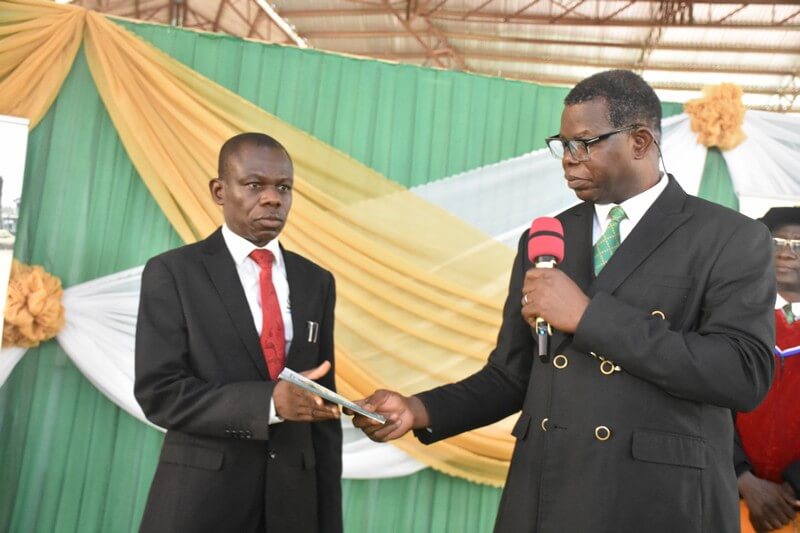 The president handing over a copy of the lecture to the registrar